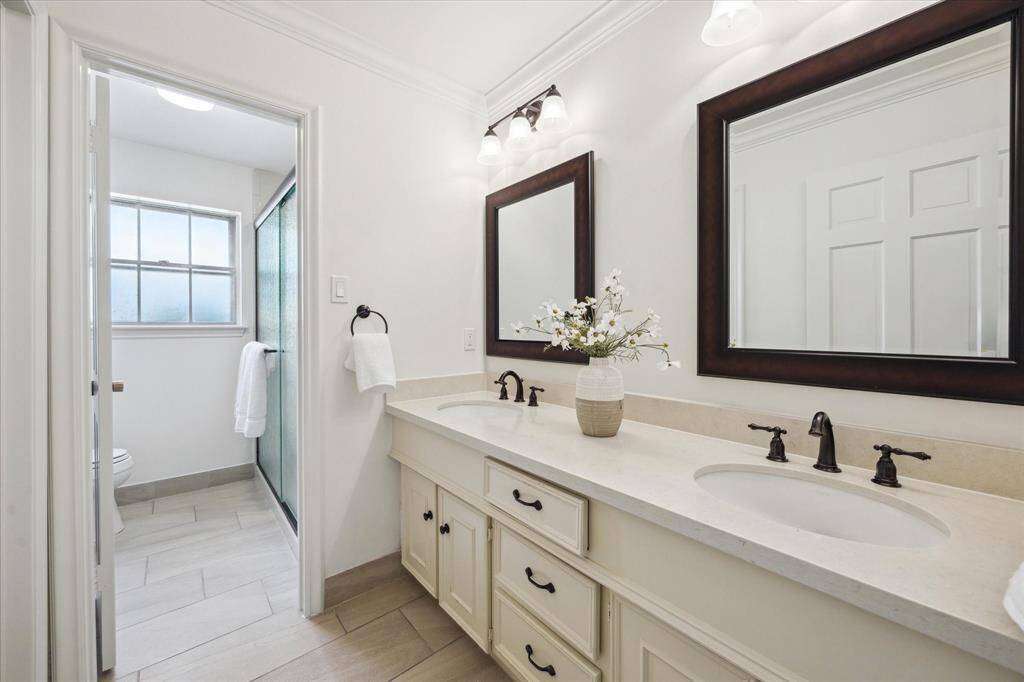 Primary bathroom with dual sinks, a separate vanity area and multiple closets. Lots of possibilities.