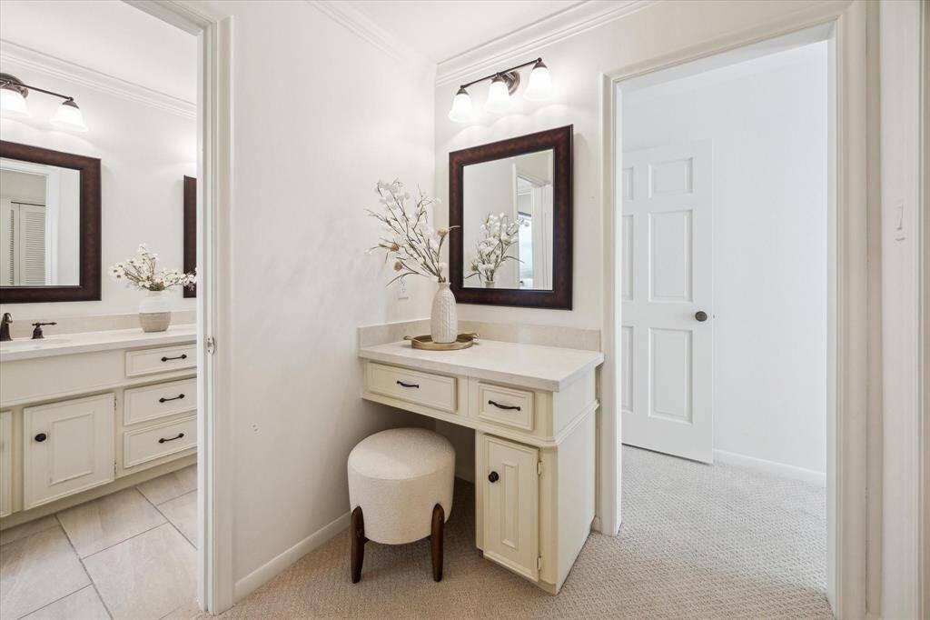 Primary bathroom with dual sinks, a separate vanity area and multiple closets. Lots of possibilities.