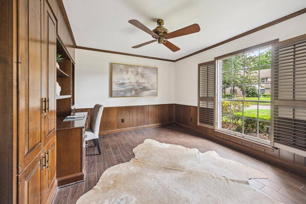 Private downstairs office ideally situated next to the Primary suite, with lots of storage and views of the front yard.