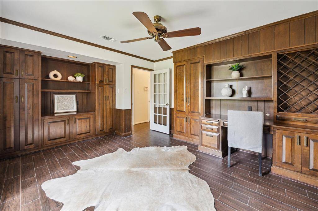 Private downstairs office ideally situated next to the Primary suite, with lots of storage and views of the front yard.