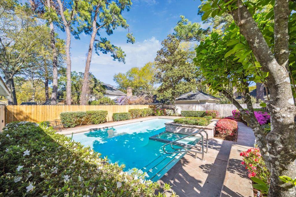 Wonderfully landscaped backyard with central pool and spa