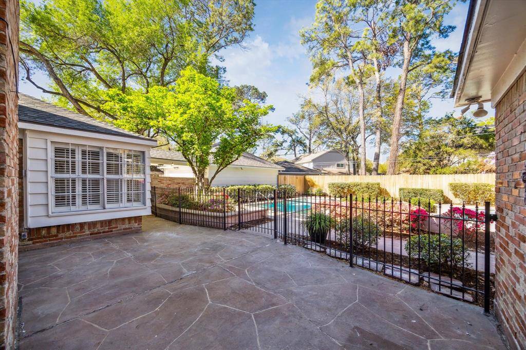 Private back patio accessible from the family room, laundry room and primary suite with gated access to the pool area. Notice no back neighbors looking in.