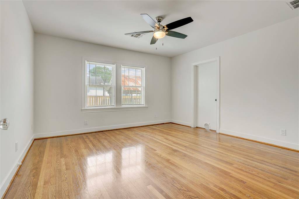 The primary bedroom is off the main hallway and shares access to the utility room.  Furry friends can also easily access the utility room as well.