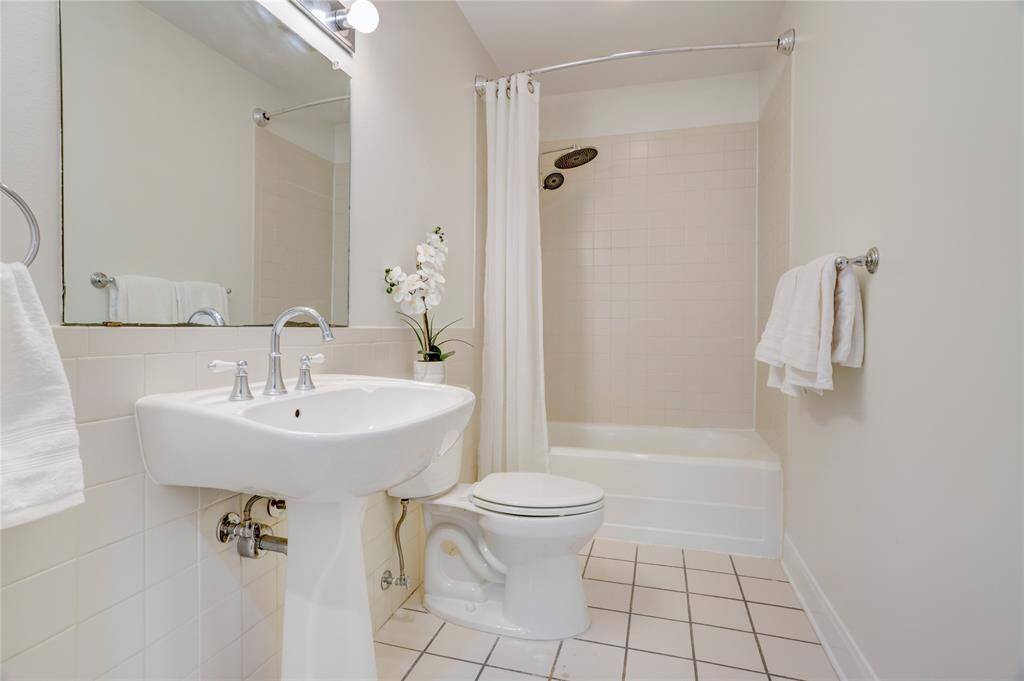 Primary hall bath with rainshower head and handheld wand.