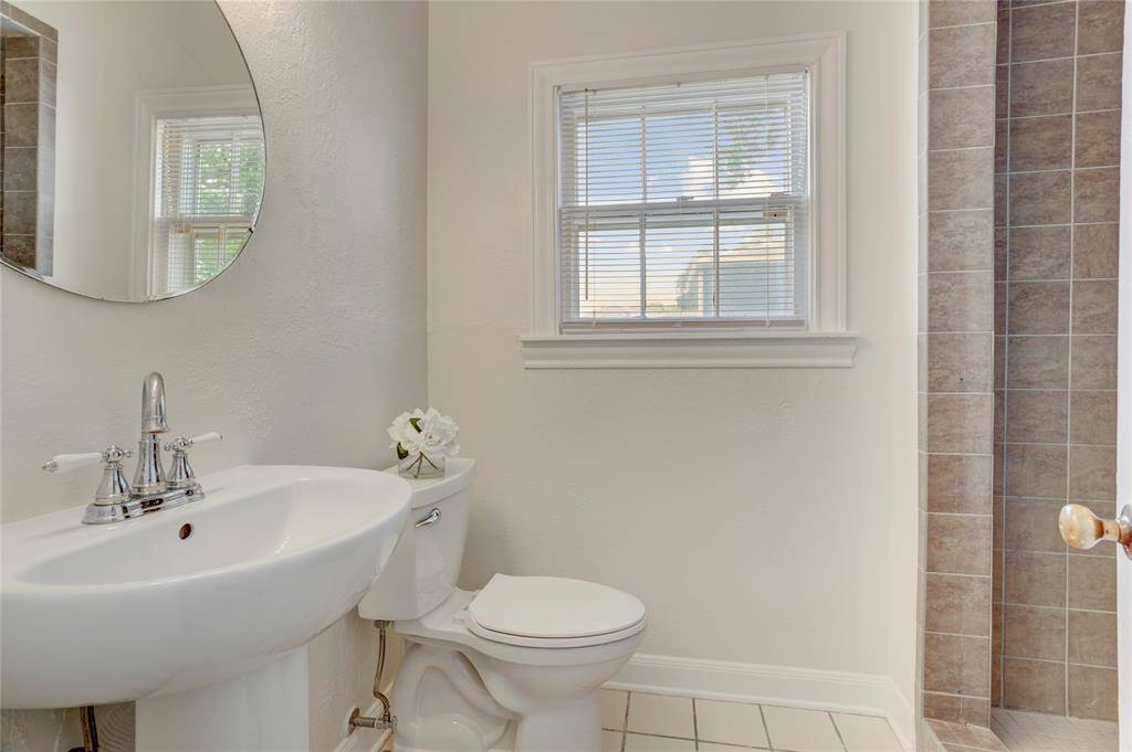 The bathroom in the back hallway features a stand alone shower.