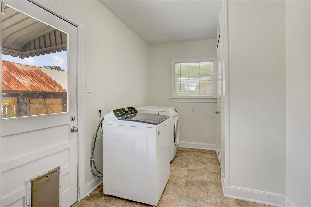 The utility room provides easy access to the patio, carport and shop.  It hold full size washer/dryer and has a storage closet with added transom.