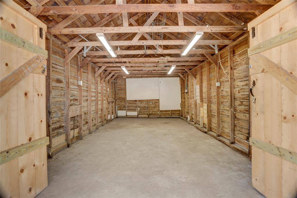 The one car garage was used by our homeowners as a workshop.  Electrical was updated and additional plugs and lighting were added through out.  On the outside wall facing the patio, additional outlets were added to accommodate an outdoor kitchen including an outdoor TV.