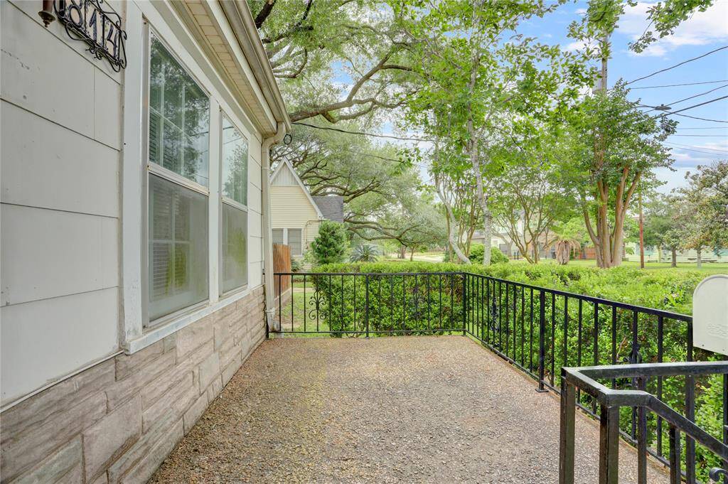 Sweet raised concrete front porch features vintage style black iron railing and small privacy gate with lock (does a great job of keeping solicitors from coming to your door). Great vantage point for enjoying a morning cup of coffee, listening to the birds and greeting your neighbors as they pass by.