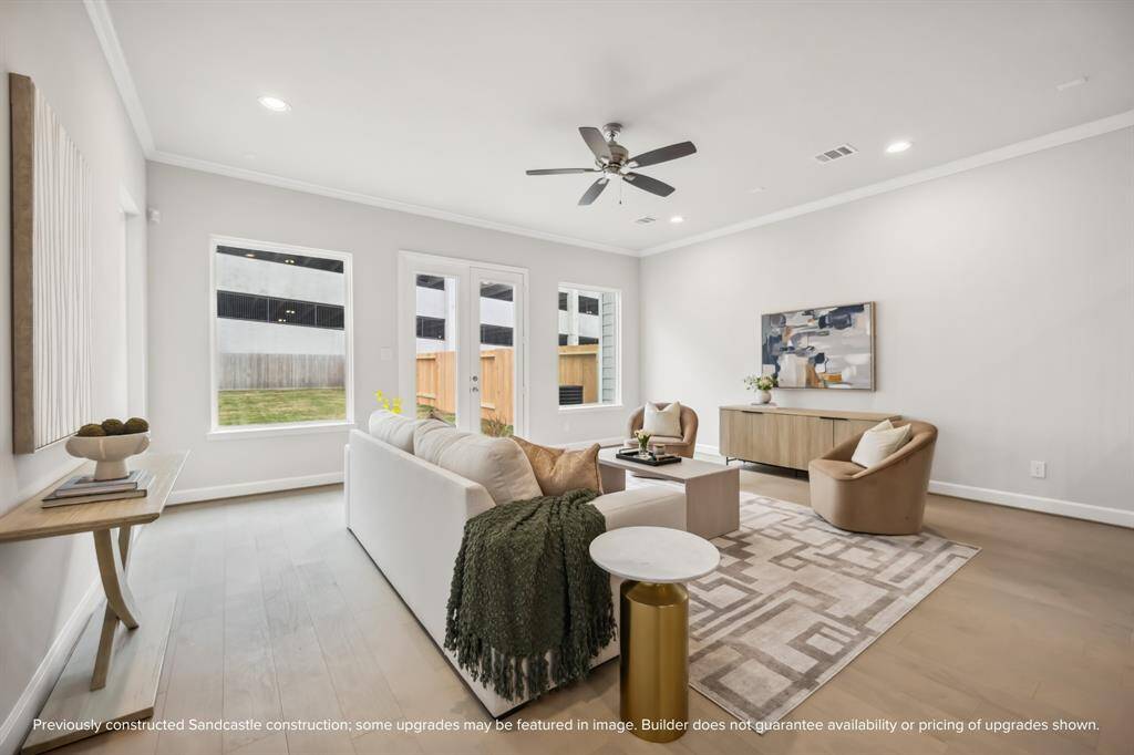French doors and large windows bring the outside in, offering stunning backyard views.