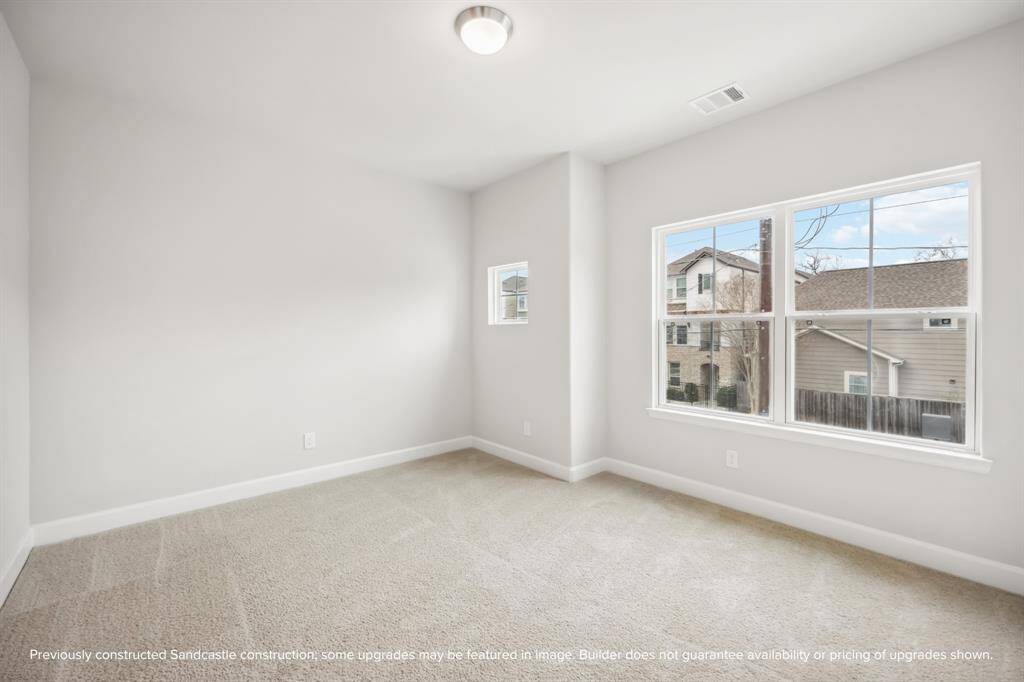 Light and spacious, this larger secondary bedroom at the front of the house shines.