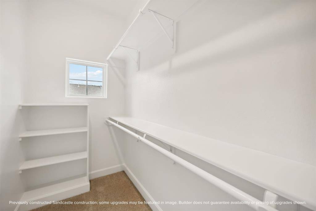 Stay Organized. This generously sized walk-in closet offers built-in shelving and ample hanging space.