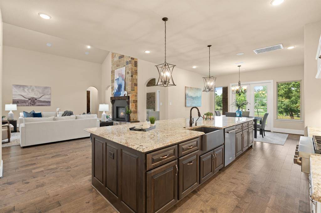 Whether you're entertaining guests or enjoying a quiet morning at home, the open-concept layout keeps everyone connected while highlighting elegant finishes, peaceful backyard views, and timeless style from every angle.