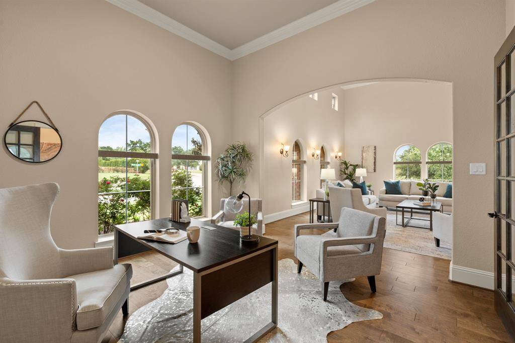 You're going to love the morning commute to this spacious study, featuring a 13' ceiling with thick crown molding, elegant arched windows, and ample room for a home-office setup. This versatile space opens to a massive game room or flex area, offering endless possibilities for work, play, or relaxation.