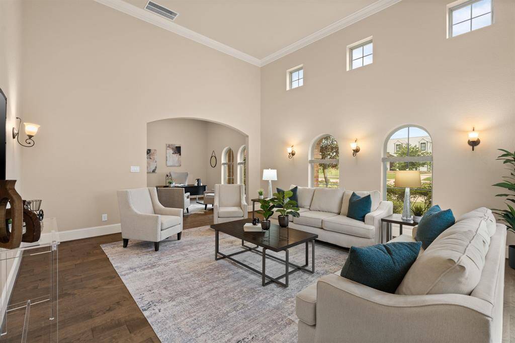 Imagine all of the possibilities in this expansive game room, with a dramatic 16' ceiling and arched windows that bathe the space in natural light. There's plenty of room for a billiard table, cozy seating, and more, making it the perfect space for game nights, casual entertaining, or simply relaxing in style.