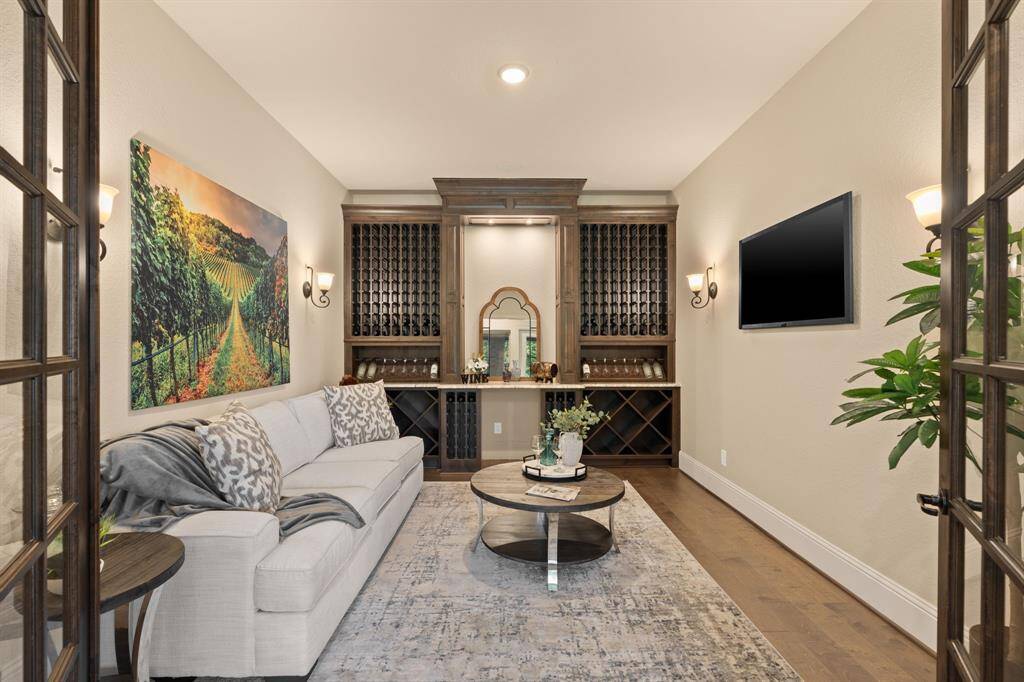 Perfect for the wine enthusiast, this elegant wine room features custom-built shelves for bottle storage with soft ambient lighting and rich engineered wood flooring. It’s the ideal space to showcase your collection, providing a cozy and inviting atmosphere for tastings and intimate gatherings.
