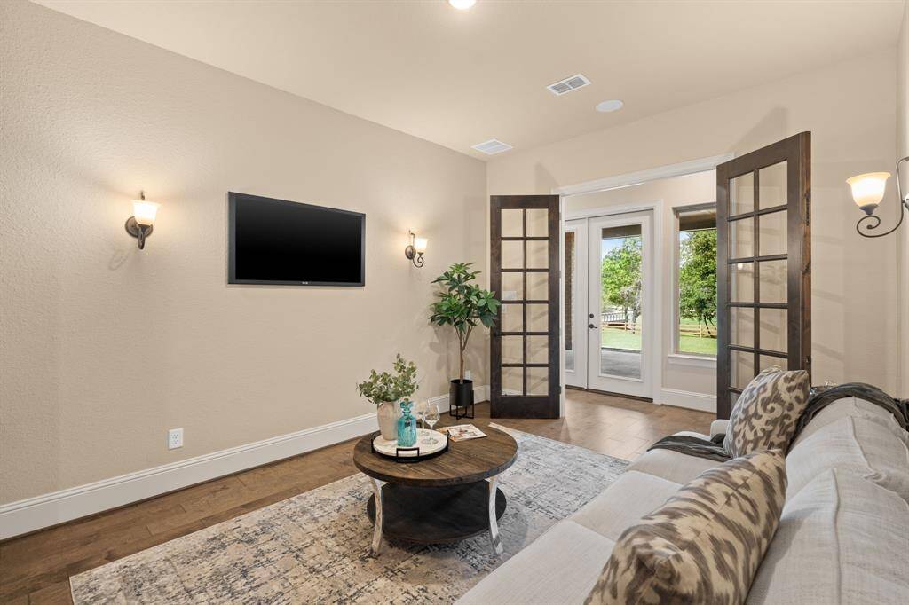 You are going to enjoy the wide flexibility of this floor plan. It offers an elegant formal dining room, a cozy casual breakfast area, an impressive family room, a serene sunroom, a private study, a versatile flex or game room, and this handsome wine room. Each space is expertly designed to provide both comfort and style, offering endless possibilities for living and entertaining.