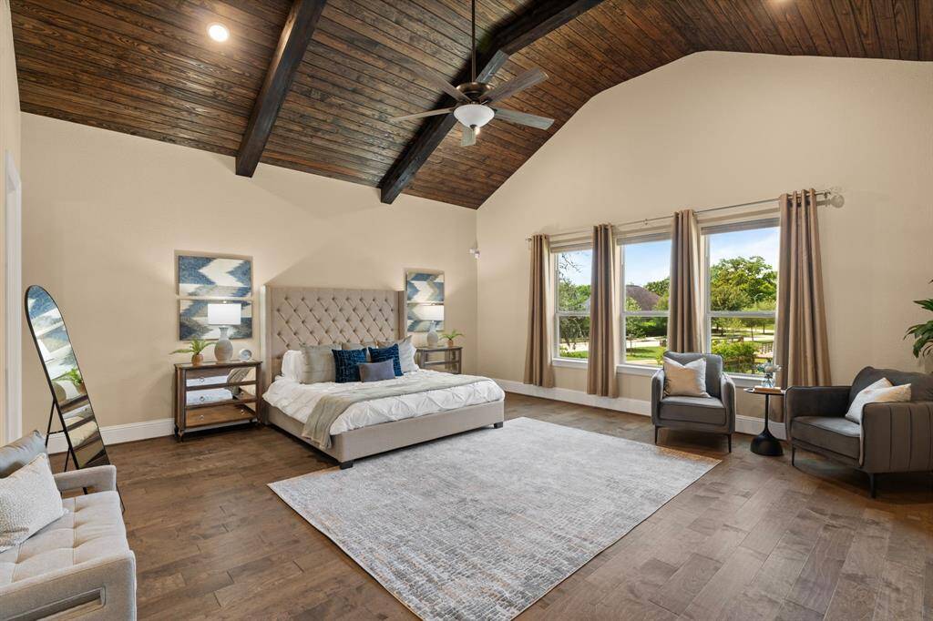 You’ll have sweet dreams in this posh owner’s retreat, where engineered wood flooring and a cathedral wood-slat ceiling create a warm, inviting atmosphere. Oversized windows fill the space with natural light, while the luxurious ensuite offers a true spa experience. The massive custom walk-in closet provides ample storage and organization, offering the perfect blend of style and functionality.