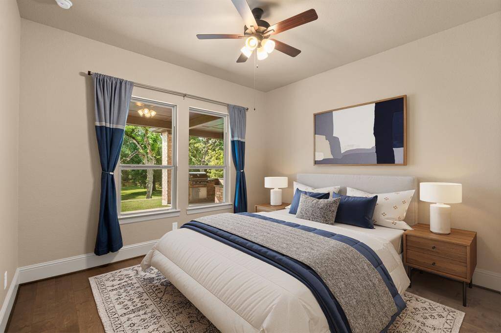 This spacious guest suite offers a comfortable retreat for family and friends, complete with a walk-in closet and a private ensuite bathroom. With plenty of room to stretch out and relax, it's the perfect space for guests to enjoy privacy and comfort during their stay. This photo is virtually staged.