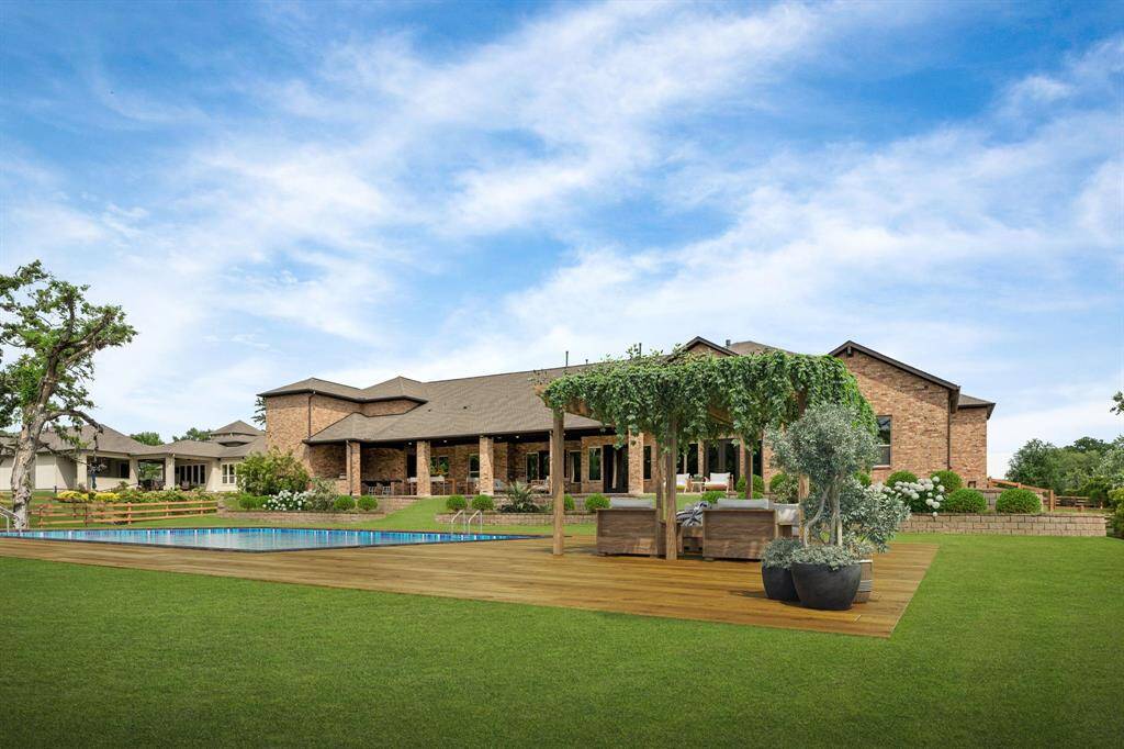Texas summers just can’t be beat when you can enjoy your own backyard pool. Picture yourself relaxing by the water, hosting poolside parties, or grilling in the covered summer kitchen. This spacious 1+ acre yard is your personal retreat, designed for endless outdoor enjoyment. This photo is virtually staged with the pool and surrounding deck.