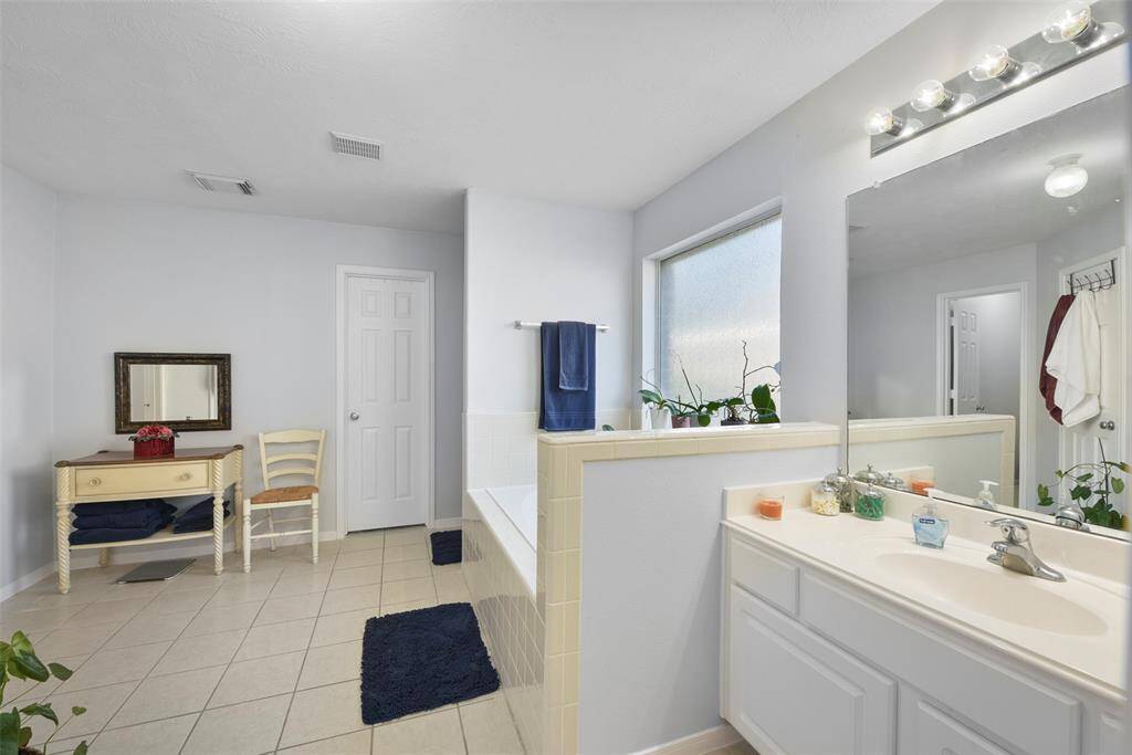The primary bath is equipped with a separate tub and shower as well as walk in closets!