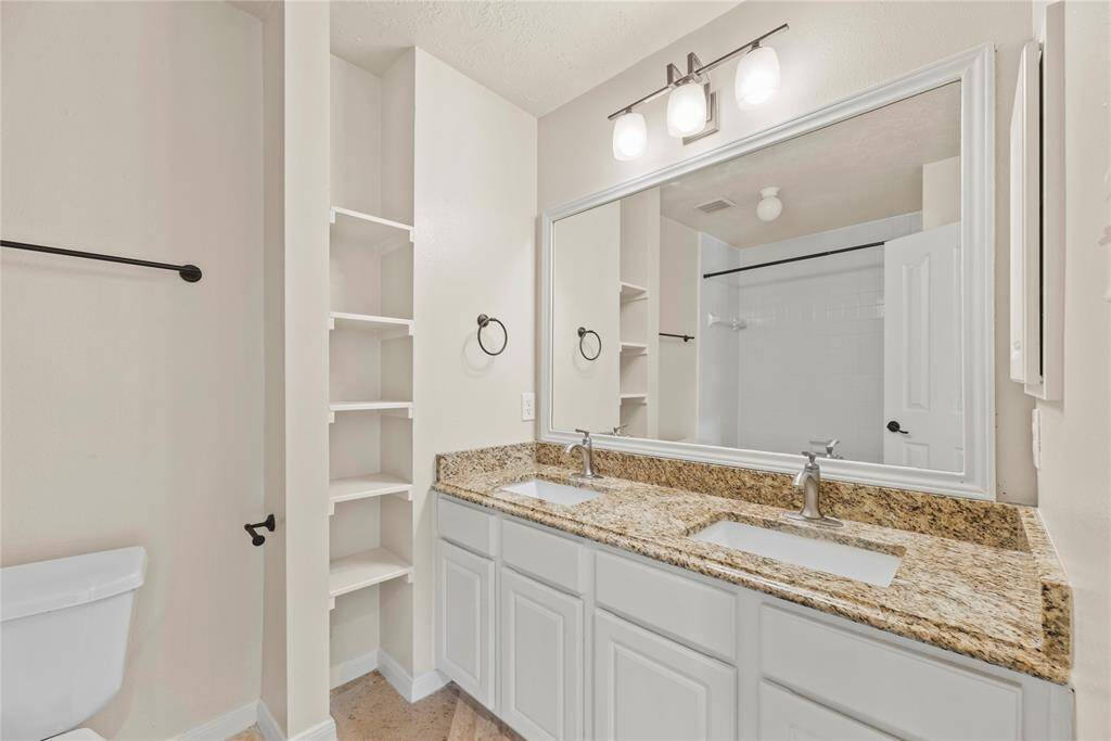 Your secondary Bathroom w double sinks and built in shelving.**8615 Westcove Circle, Houston, TX 77064**