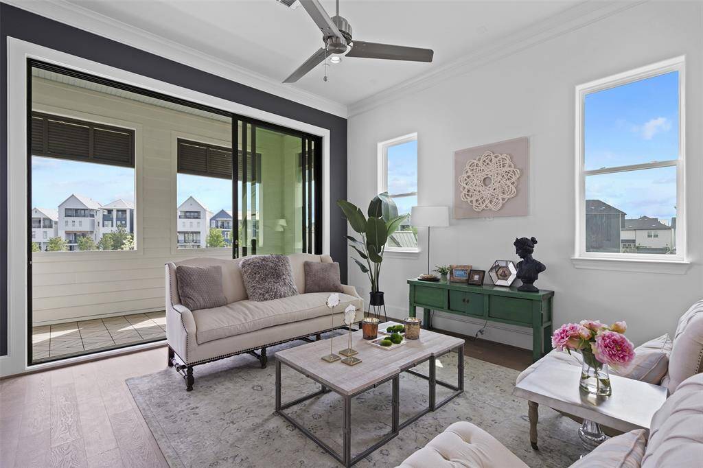 10 FT Tall by 12 FT Wide - Tri-Paneled Sliding Glass Doors Open to Lakeside Balcony