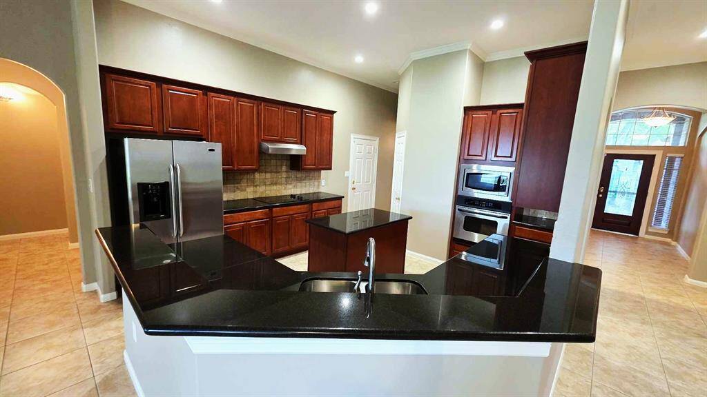 Black granite counter tops, double oven, island