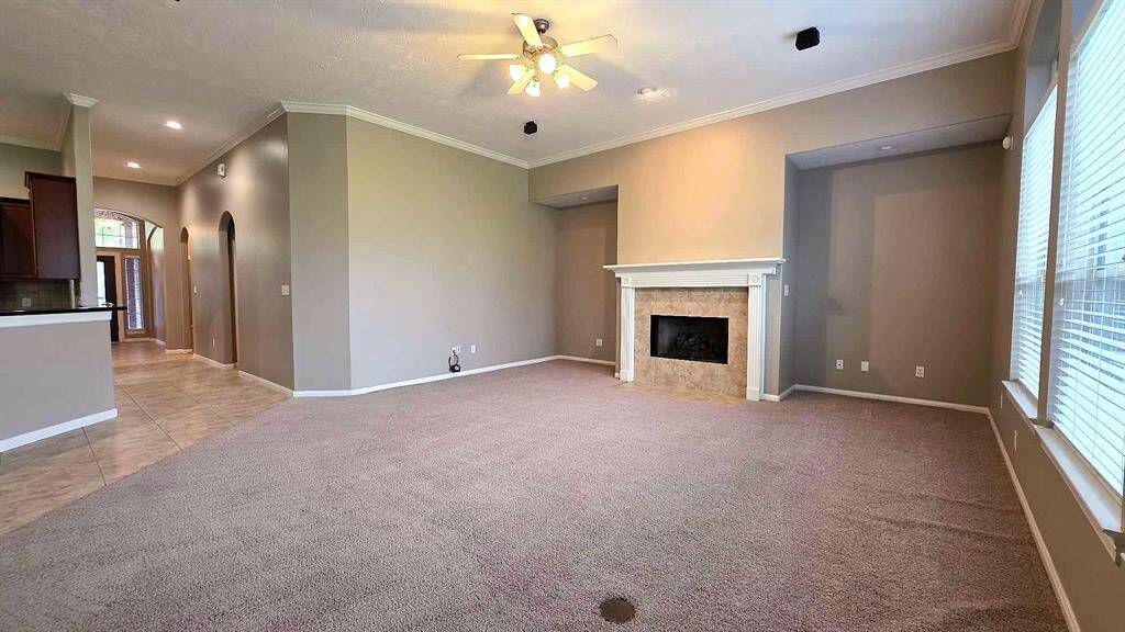 The cozy fireplace and high ceilings make the family room inviting