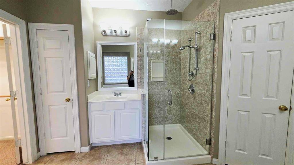 Gorgeous frameless shower, linen closet and private water closet