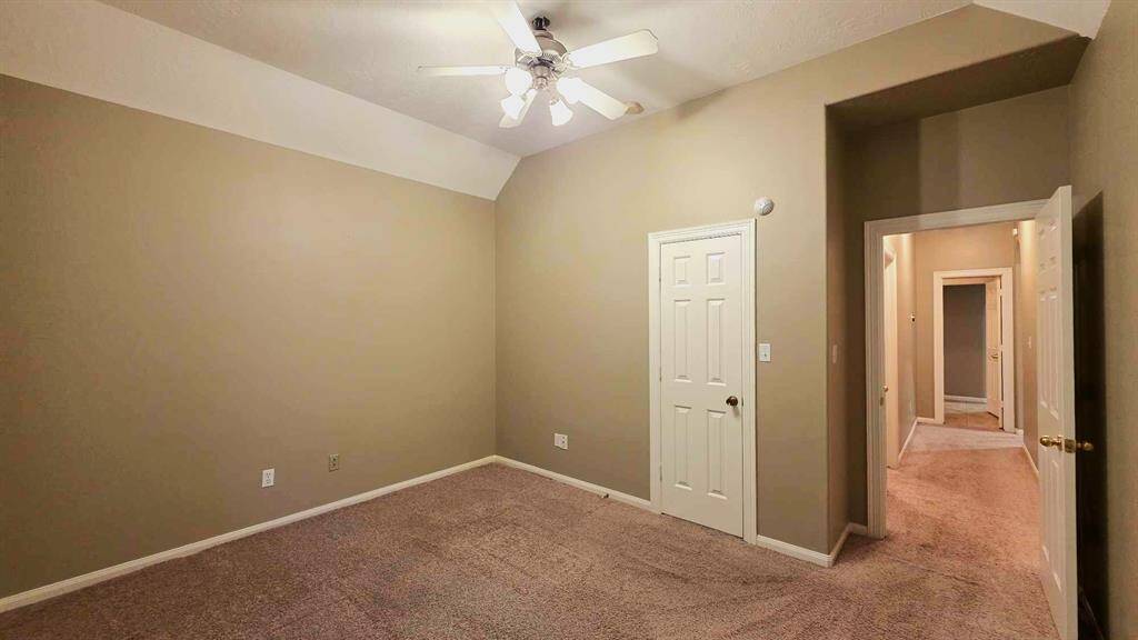 Secondary bedroom #1 is almost 13x14' with high ceilings, ceiling fan and large walk in closet