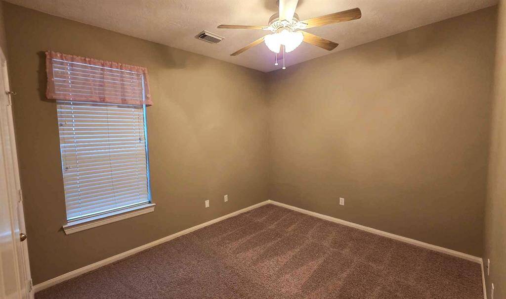Secondary bedroom #2 is 12 x 10', with a ceiling fan and walk in closet