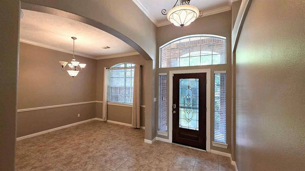Enter into your beautiful custom home underneath an extra large transom window.