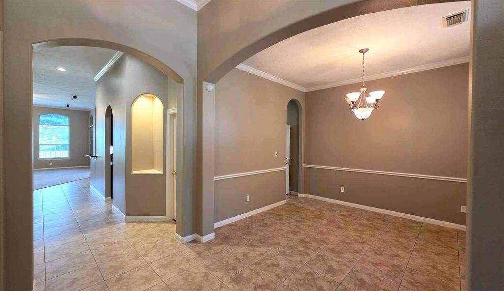 A view from the foyer shows the 12x13' dining room and hall to the family room