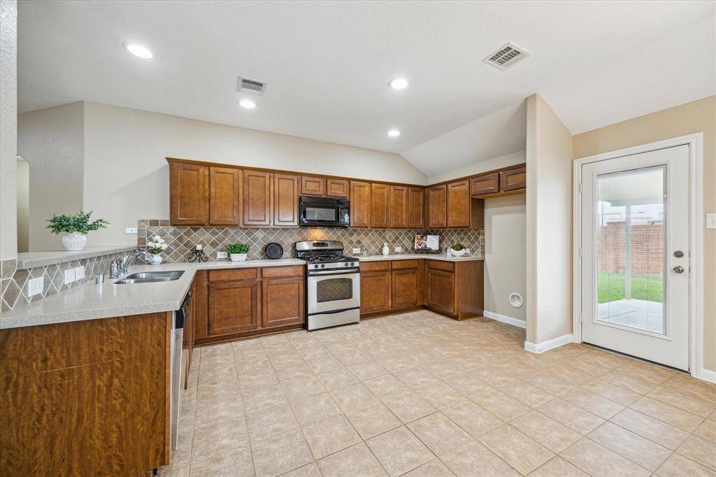 Modern kitchen featuring ample cabinetry and a breakfast bar and bright dining nook adjacent to the kitchen, perfect for at home meals.