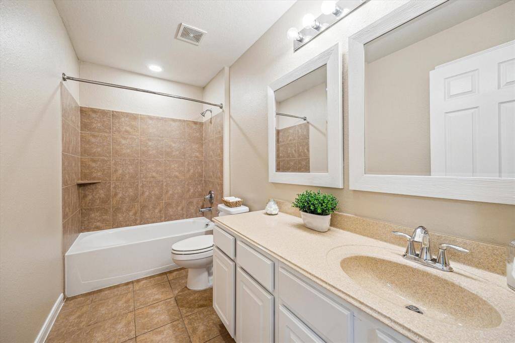 The hall bathroom provides easy access for guests and features updated fixtures, a tub/shower combo, and stylish tile – a functional addition to this thoughtfully designed home