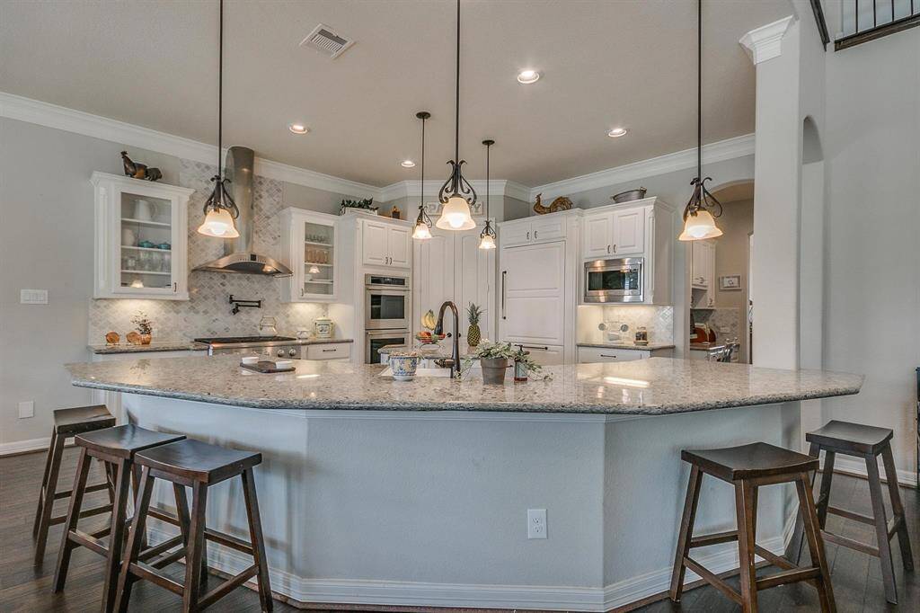 Kitchen opens to breakfast and family room.