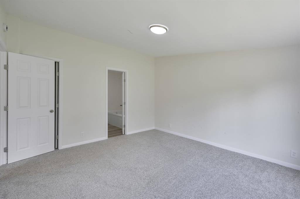 Primary Bedroom. Primary bathroom in the center. Walk in closet behind the door.