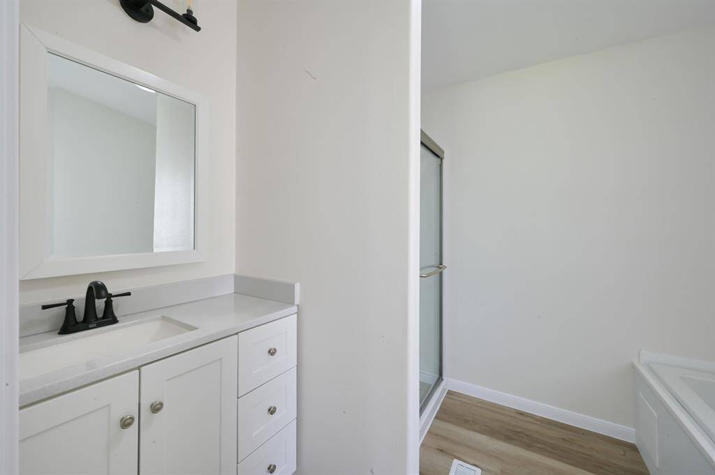 Primary bathroom. All new cabinet, sink, tub, and walk in shower.