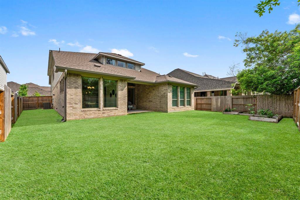 Sprawling backyard with covered patio offers plenty of space to design your dream pool.
