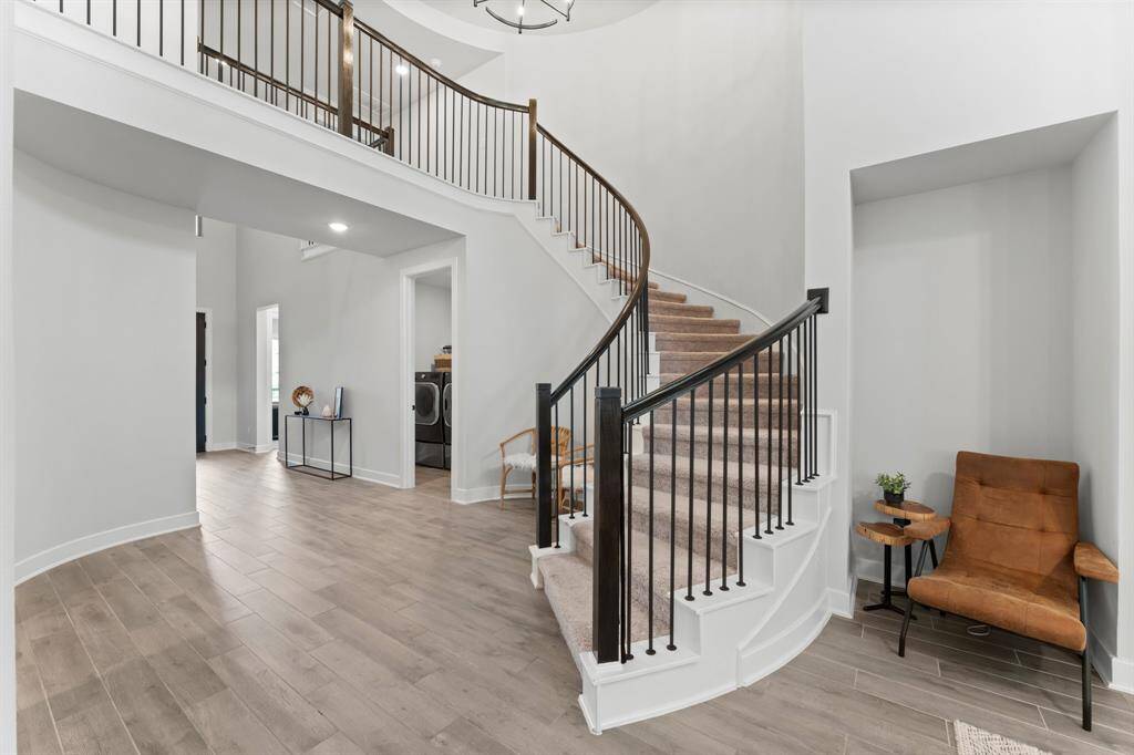 Beautiful wood-like tile throughout the living areas, cascading staircase and plentiful natural light.