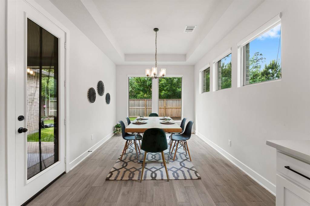 Charming breakfast nook off the kitchen offers plenty of space for hosting, and features access to outdoor patio.