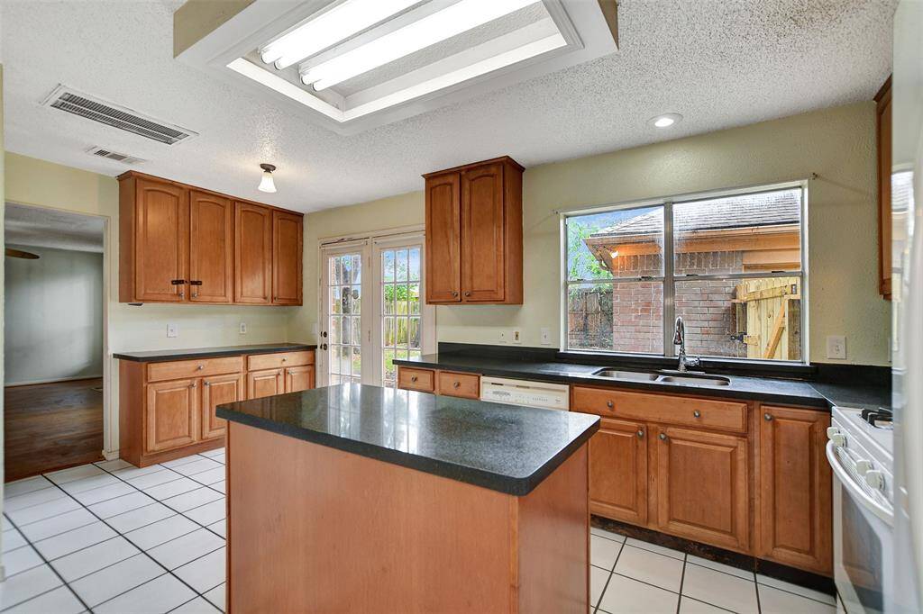 This is an entertainers kitchen with ample storage, prep space and serving area.