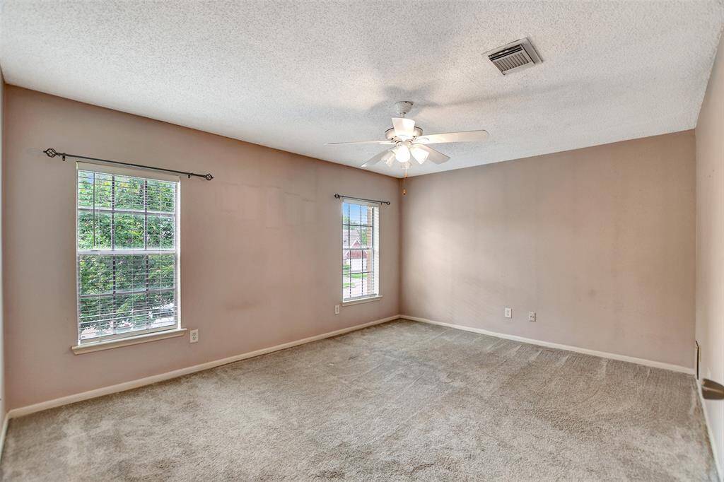 This primary bedroom has so much space. Plus, soft carpet for your feet.
