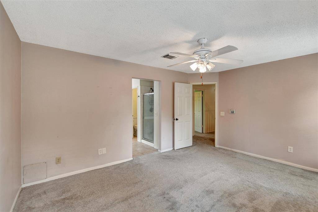 Plenty of room for your bed, side tables, a dresser, desk with room to spare! The open door way leads you into the primary en-suite.