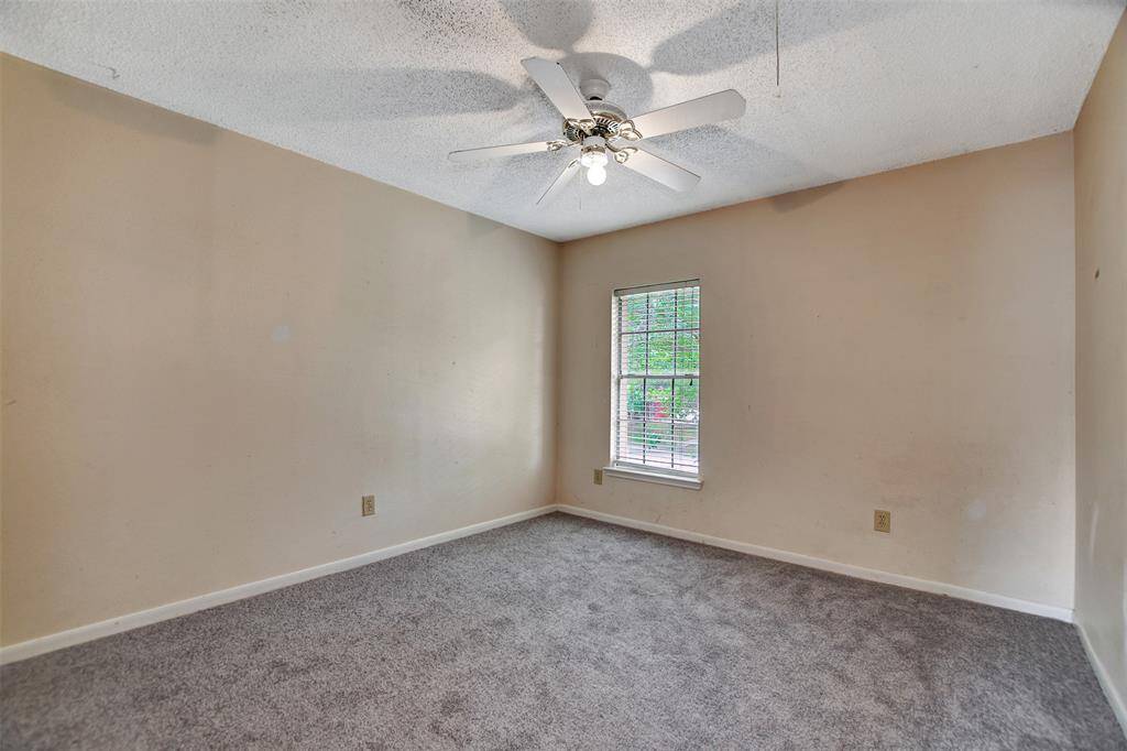 Another bedroom with brand new carpet and views of the front yard.