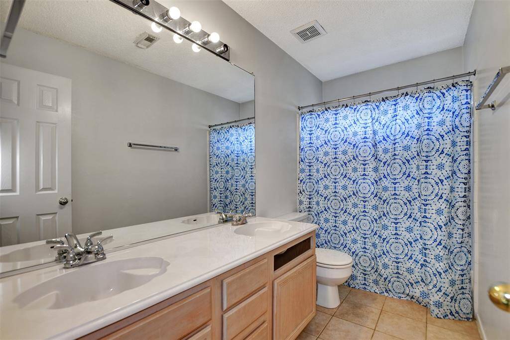 Secondary bathroom has double sinks, counter space for all of your products, and cabinets below for storage!