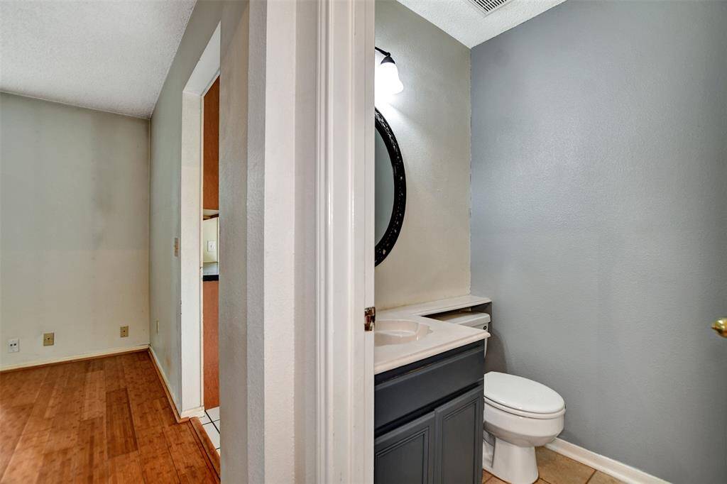 The half bath is conveniently located off the entry hallway but not too close to the living and dining areas to provide added privacy.