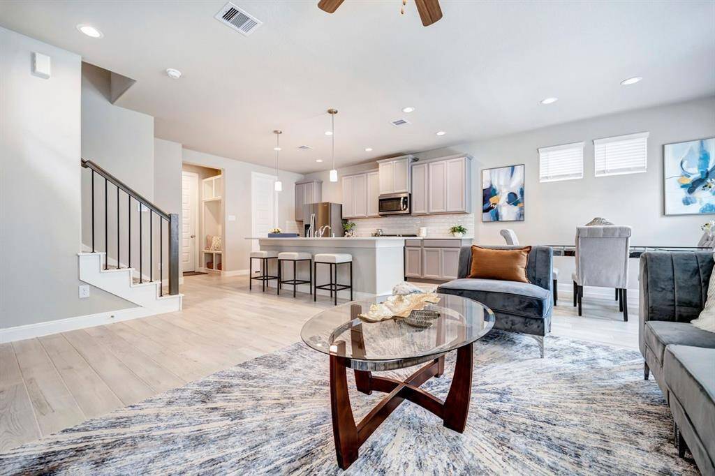 Another angle of the living room, looking into the kitchen.  Beautiful tile floors with a wood look offer durability and sophisticated finishes.