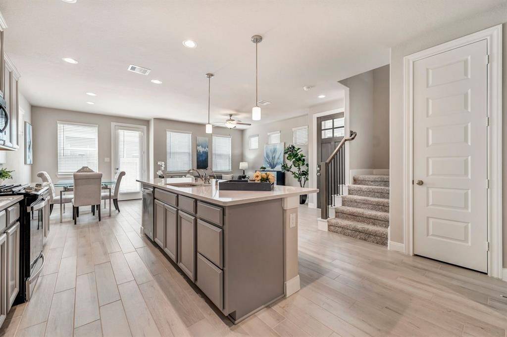 Featuring quartz countertops, ample cabinetry and stainless appliances, the kitchen is built to handle everything from quick weekday meals to gourmet dinner parties.