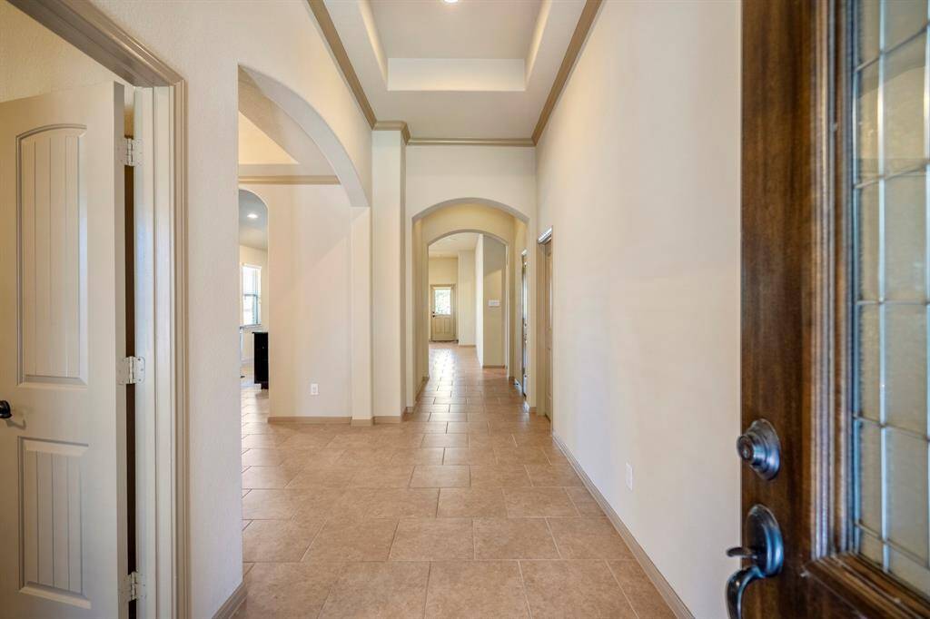 Welcoming entry with tiled flooring and tray ceiling and nice architectural details throughout.